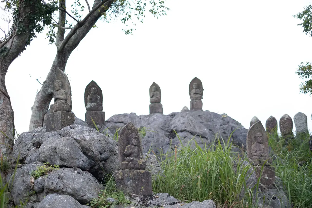 石灰岩の岩塊に並ぶ石仏（平尾石仏）と枯れ草